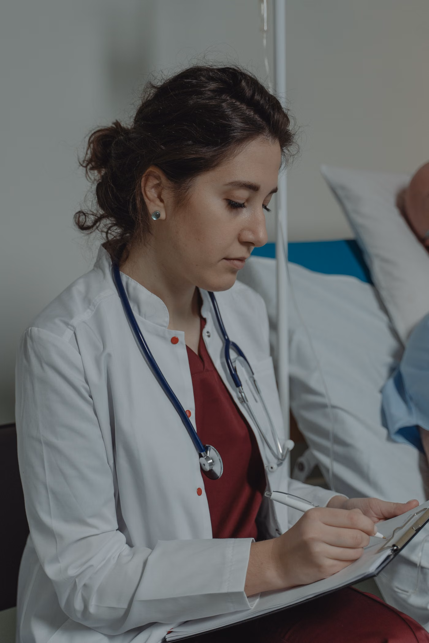 Doctor making written notes in a clinical setting