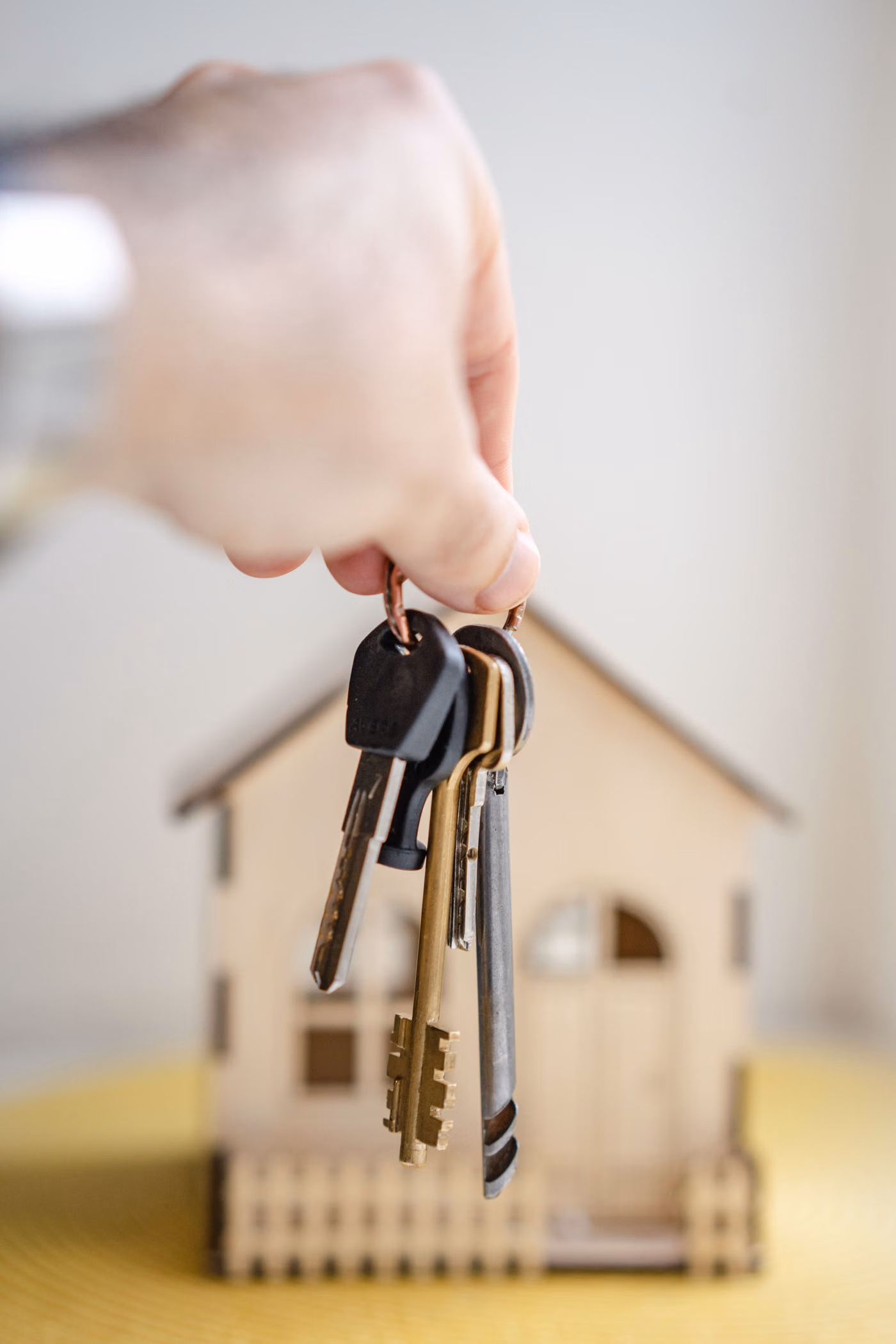 Hand holding house keys during a property handover