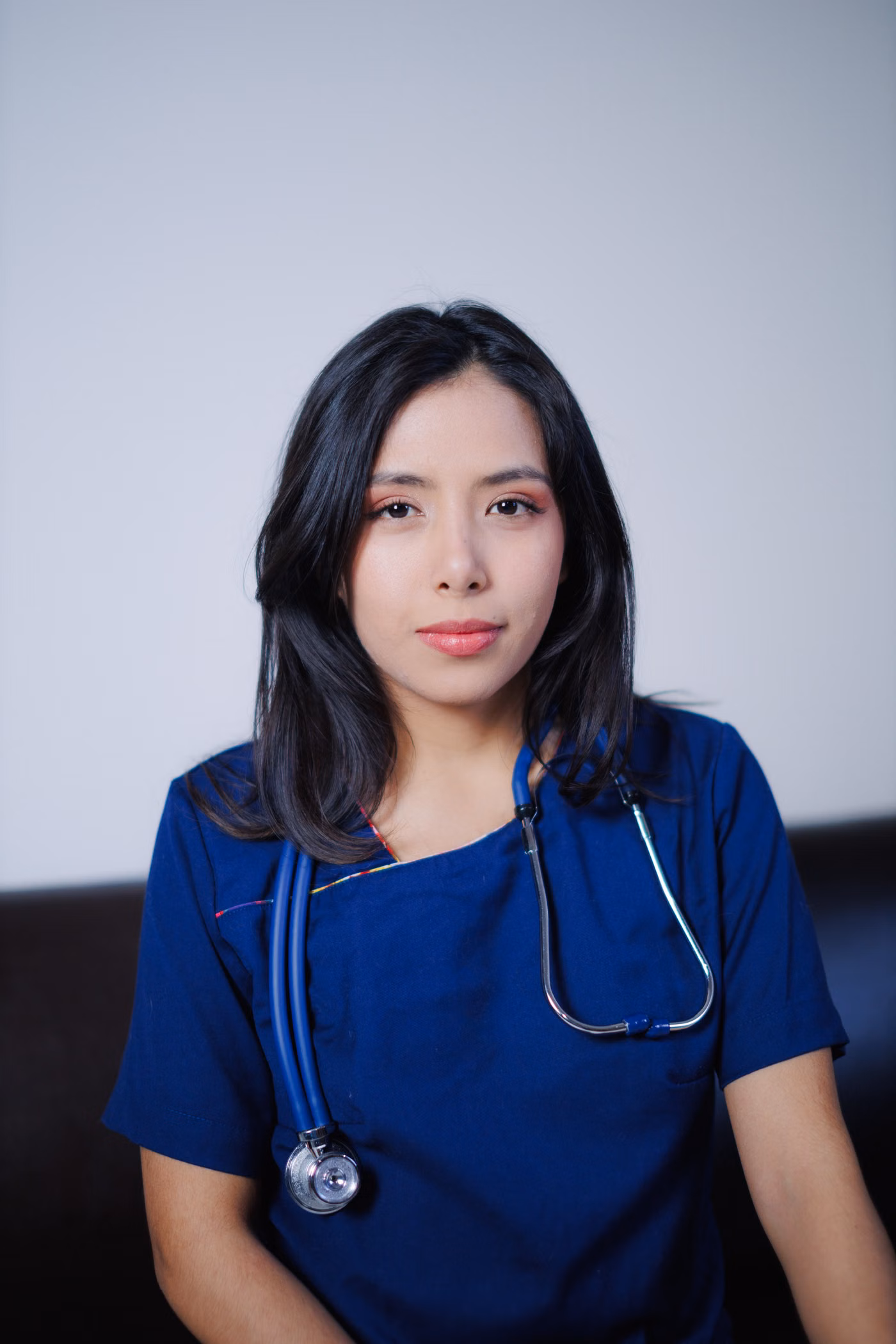 Nurse in blue uniform holding a stethoscope
